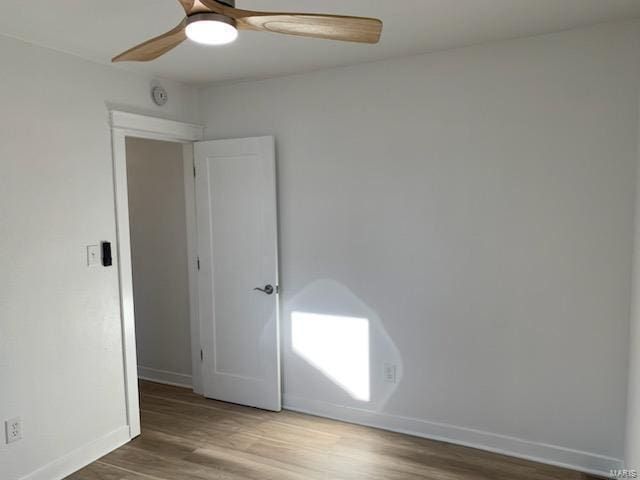 empty room featuring hardwood / wood-style flooring and ceiling fan