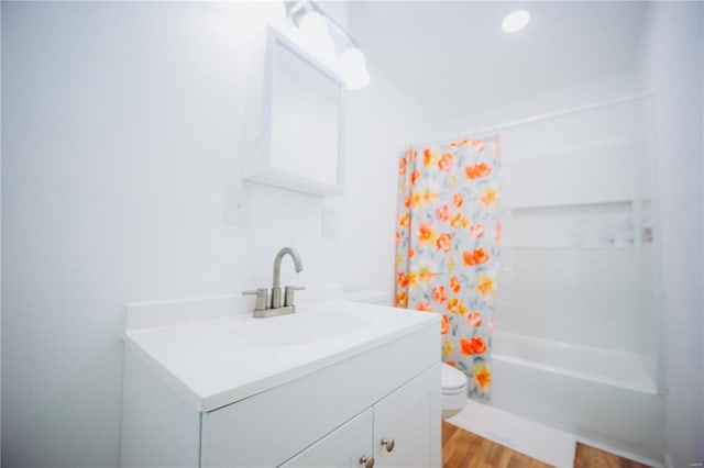 full bathroom featuring vanity, toilet, shower / tub combo with curtain, and hardwood / wood-style flooring