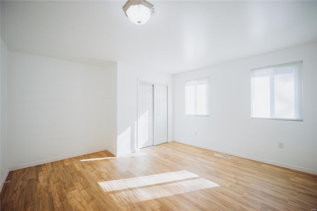 spare room with hardwood / wood-style floors