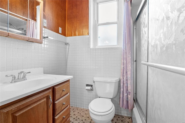 full bathroom featuring vanity, bathing tub / shower combination, tile patterned flooring, toilet, and tile walls