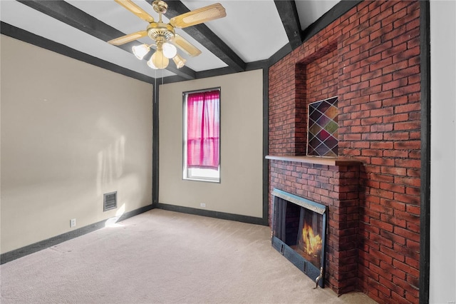 unfurnished living room featuring beamed ceiling, light carpet, a brick fireplace, and ceiling fan