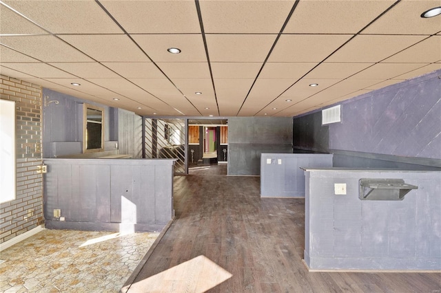 kitchen with dark hardwood / wood-style flooring and a drop ceiling