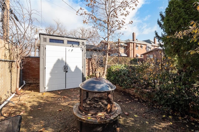 exterior space featuring a shed and an outdoor fire pit