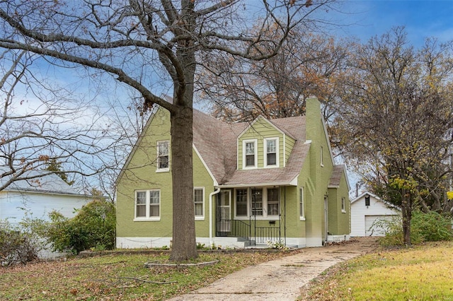 view of front of house featuring an outbuilding, a porch, and a garage