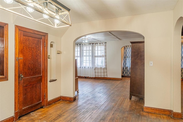 hallway with dark hardwood / wood-style flooring