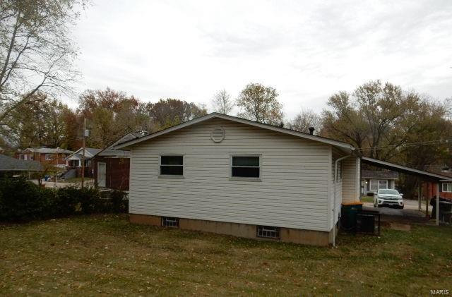 view of property exterior with a yard