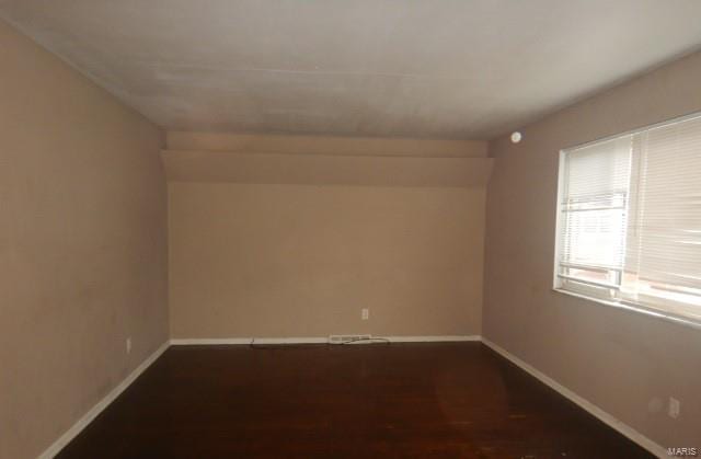 unfurnished room featuring dark hardwood / wood-style floors