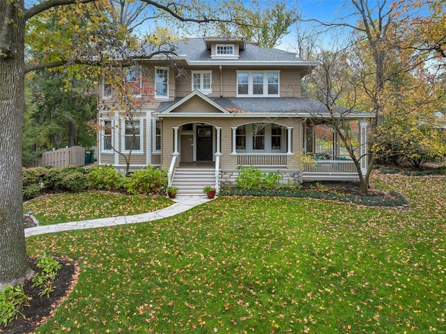 view of front of house with a porch and a front yard