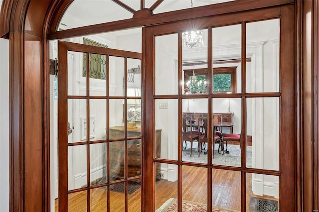 doorway to outside with wood-type flooring and french doors