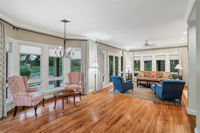 interior space featuring ceiling fan with notable chandelier