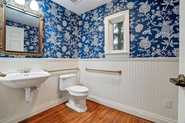 bathroom with hardwood / wood-style floors and toilet