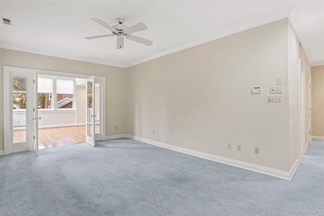 carpeted empty room with ceiling fan and crown molding