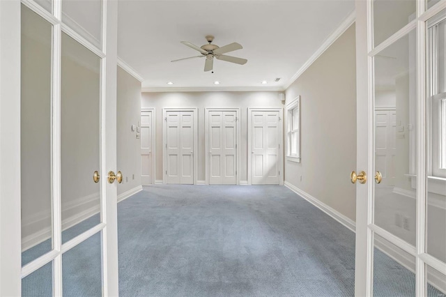 unfurnished bedroom featuring carpet, french doors, two closets, ceiling fan, and ornamental molding