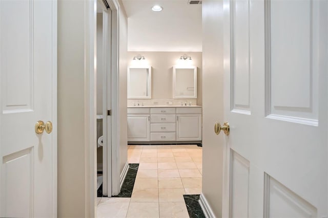 bathroom with tile patterned flooring and vanity