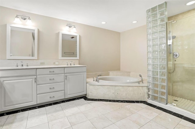 bathroom with tile patterned floors, vanity, and shower with separate bathtub