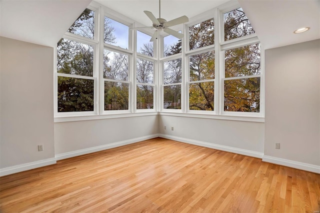 unfurnished sunroom with ceiling fan, a healthy amount of sunlight, and vaulted ceiling