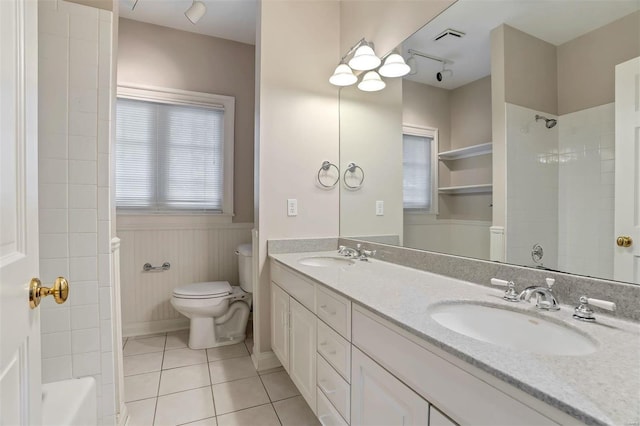 bathroom featuring wooden walls, tile patterned flooring, vanity, and toilet