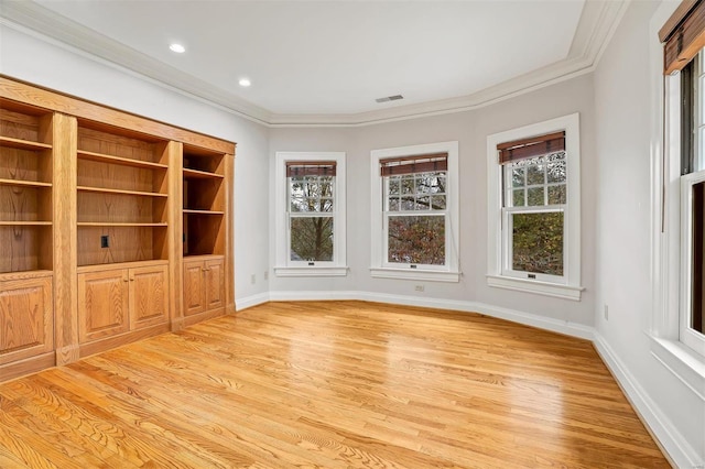 interior space with ornamental molding and light hardwood / wood-style flooring