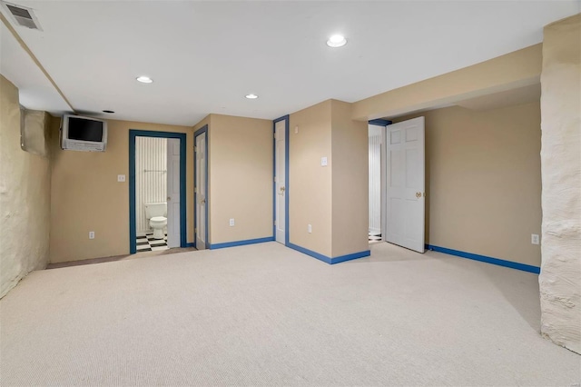 basement featuring light colored carpet