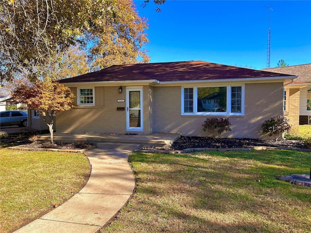 ranch-style house with a front lawn