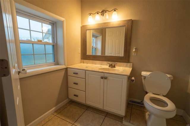 bathroom with tile patterned flooring, vanity, and toilet