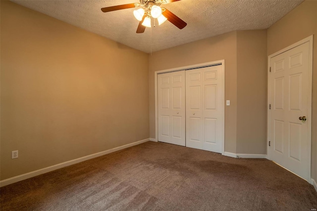 unfurnished bedroom featuring carpet, ceiling fan, a textured ceiling, and a closet