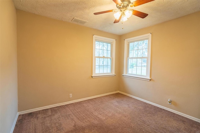 carpeted spare room with ceiling fan and a textured ceiling