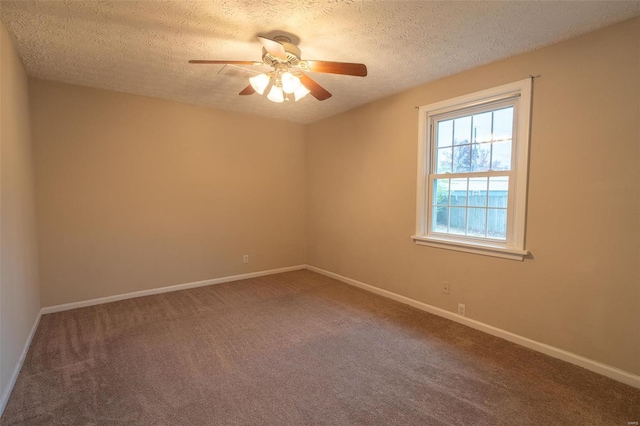 unfurnished room with ceiling fan, carpet, and a textured ceiling