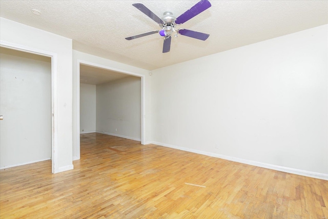 spare room with ceiling fan, a textured ceiling, and light hardwood / wood-style flooring