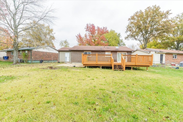 back of house with a yard and a wooden deck