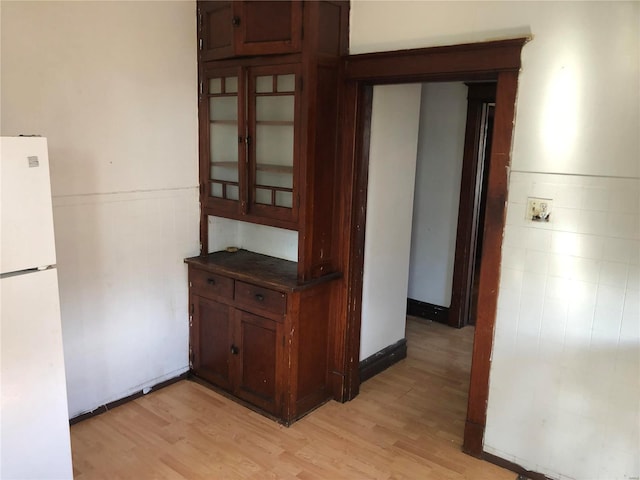 corridor with light hardwood / wood-style floors