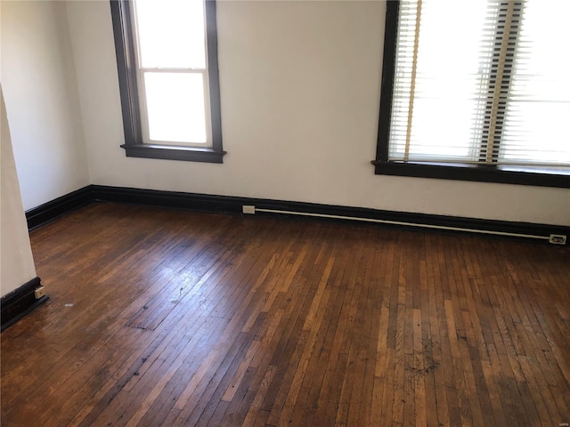 spare room with dark hardwood / wood-style flooring