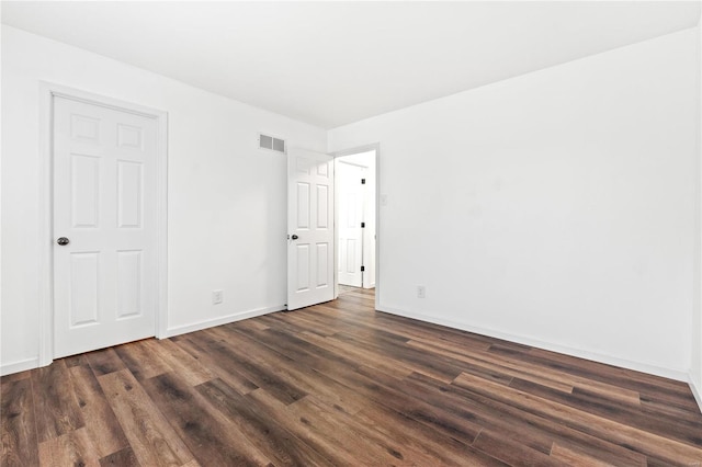 unfurnished room featuring dark hardwood / wood-style flooring