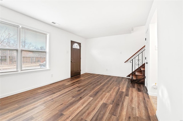 entryway with dark hardwood / wood-style flooring