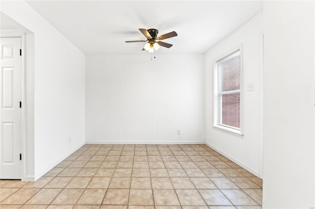 tiled empty room with ceiling fan