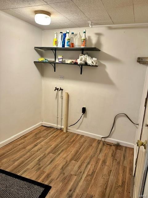 clothes washing area with hardwood / wood-style flooring