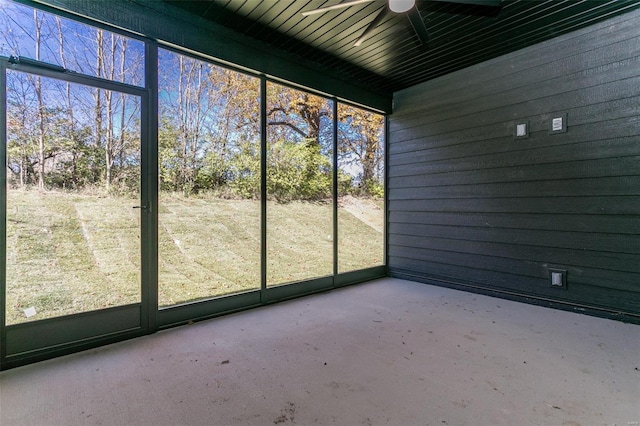 unfurnished sunroom featuring ceiling fan