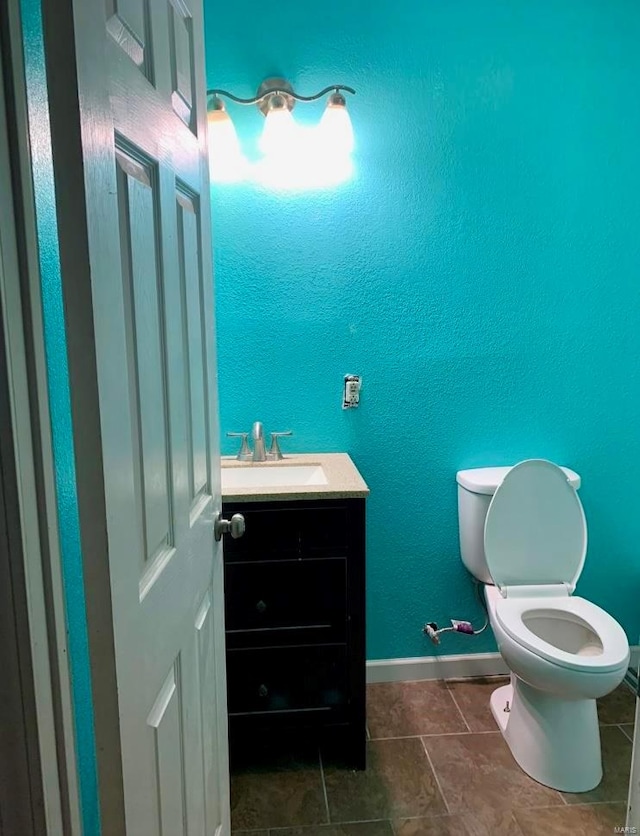 bathroom with tile patterned floors, vanity, and toilet