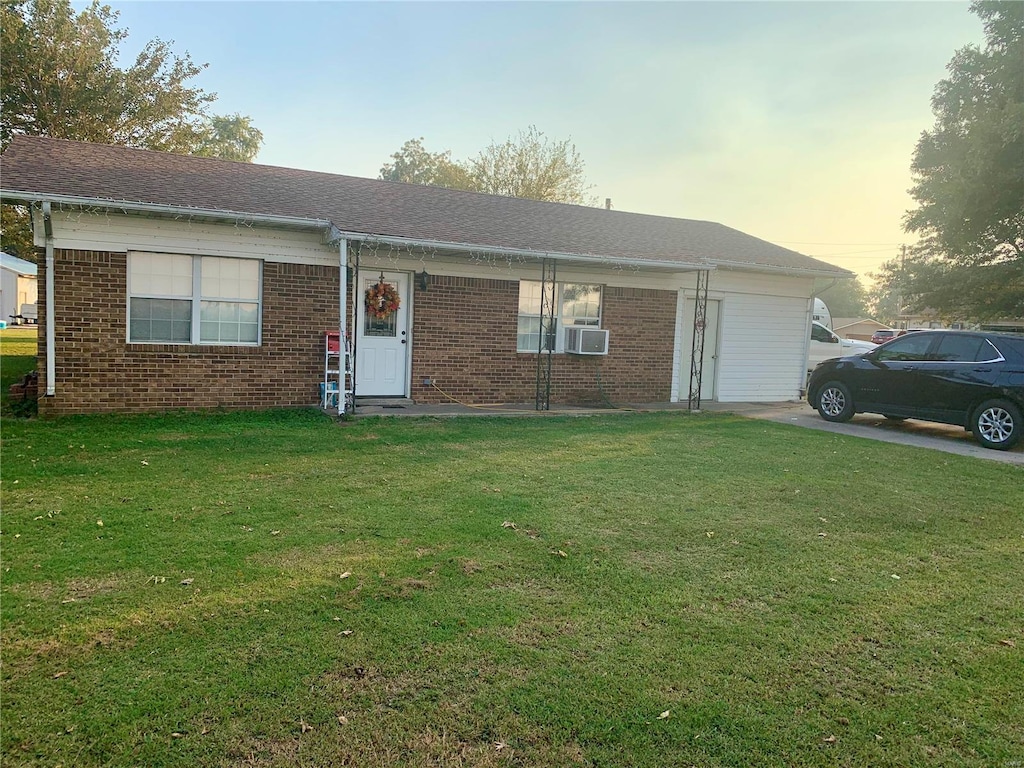 single story home with cooling unit and a lawn