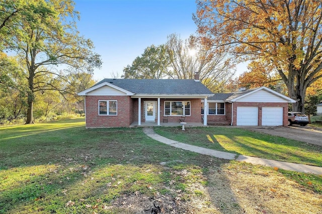 single story home featuring a garage and a front lawn