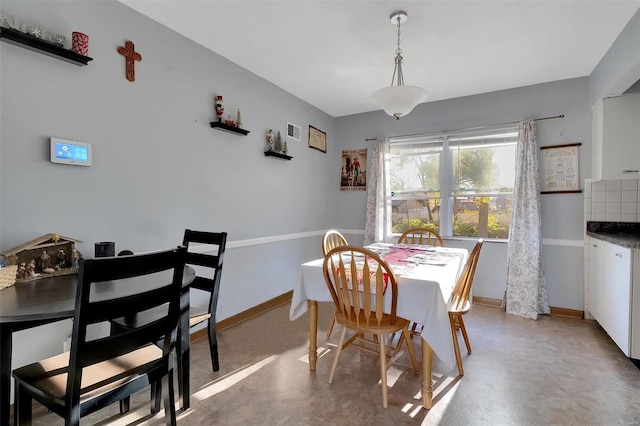 dining room with concrete flooring