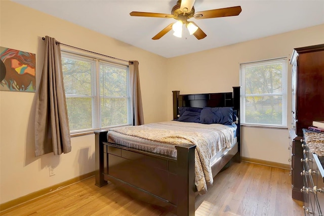 bedroom with light hardwood / wood-style floors and ceiling fan