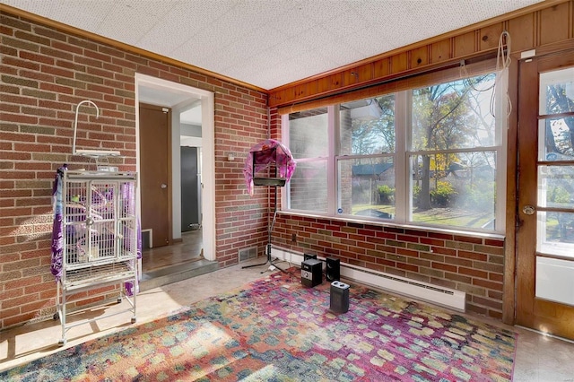 sunroom featuring plenty of natural light and a baseboard radiator