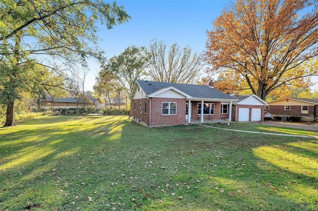 view of front of home featuring a garage, covered porch, and a front lawn