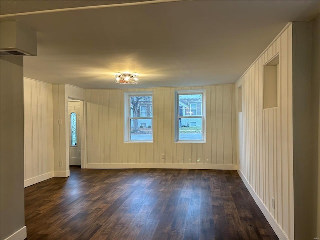 empty room with dark hardwood / wood-style flooring