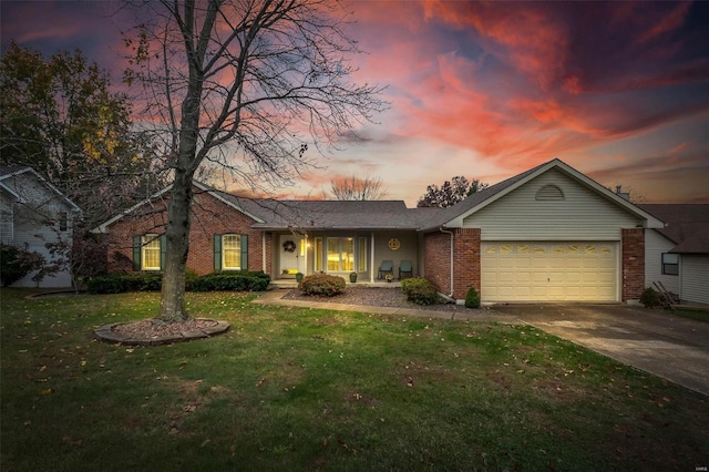 single story home with a lawn and a garage