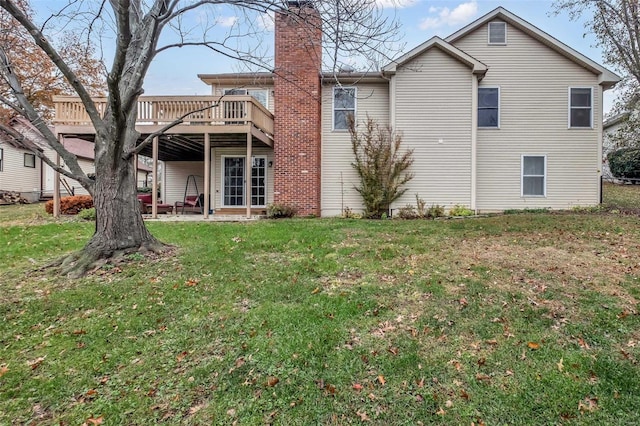 rear view of house with a patio area, a deck, and a yard