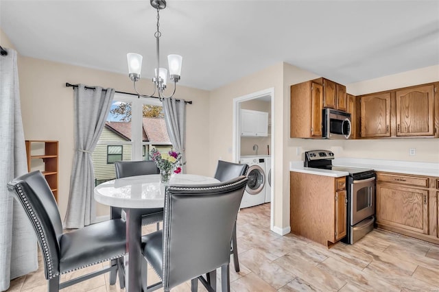 dining area featuring a notable chandelier and separate washer and dryer