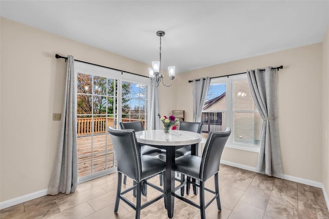 tiled dining area with a wealth of natural light and an inviting chandelier