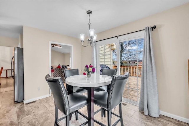 dining room featuring ceiling fan with notable chandelier